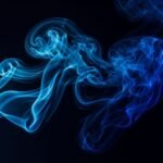 Blue smoke on black background image