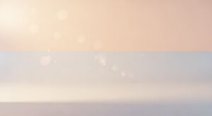 Blurry image of a beach with a sunset in the background Background Image