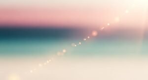 Blurry image of a beach with lights on it Background Image