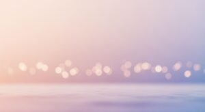 Blurry image of a body of water with lights in the background Background Image