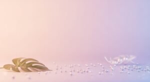 Gold leaf sitting on top of a table next to pearls Background Image