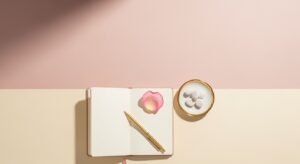 Notebook with a pen and a rose on top of it Background Image