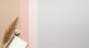 Notepad and a plant on a pink and blue background Background Image
