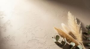 Pampas grass and eucalyptus leaves on a wall Background Image