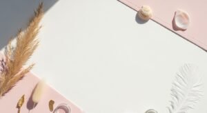 Pink and white table with shells and feathers on it Background Image