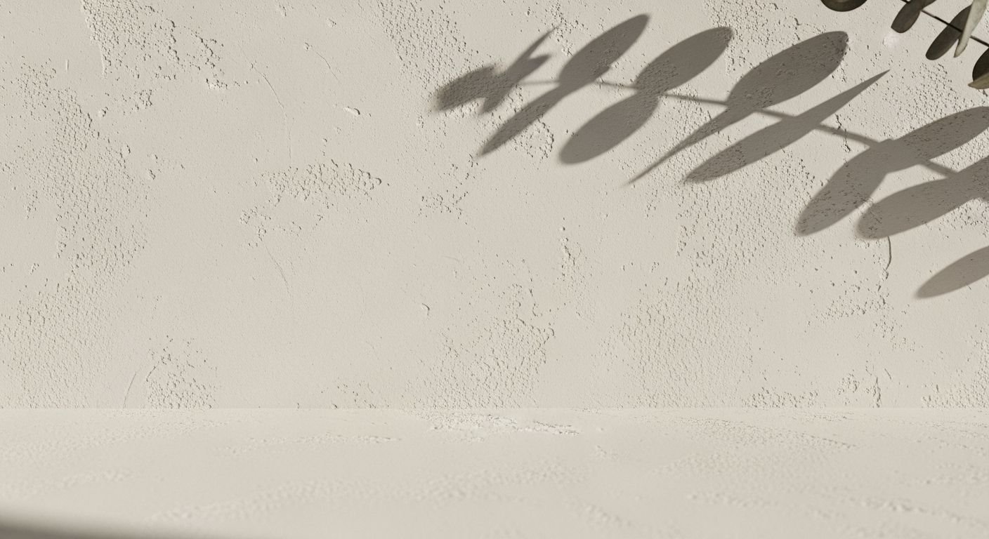 Shadow of a plant on a white wall Background Image