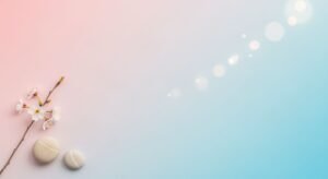 Two bath bombs and a branch with flowers on a pink and blue background Background Image