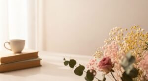 Vase of flowers and a cup of coffee on a table Background Image