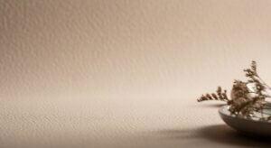 Vase with dried flowers sitting on top of a table Background Image