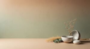 White bowl sitting on top of a table next to a plant Background Image