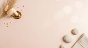White candle sitting on top of a table next to a napkin Background Image