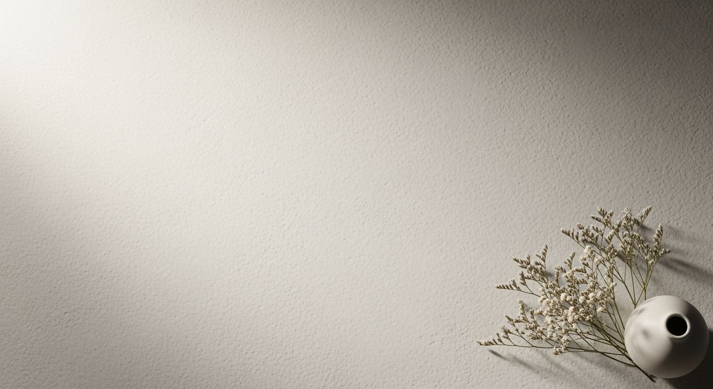 White vase sitting on top of a table next to a wall Background Image